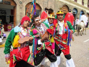 Men dancing in traditional costume in Cusco, Peru