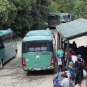 2 Green Shuttle Buses waiting to depart from Machu Picchu