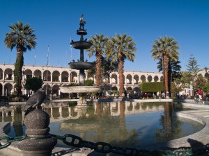 Plaza with palm trees. pond and ornate building behind, Arequipa, Peru