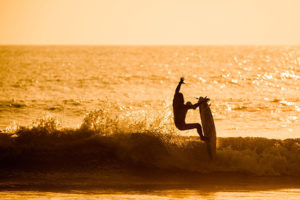 best beaches in peru - man surfing at huanchaco beach